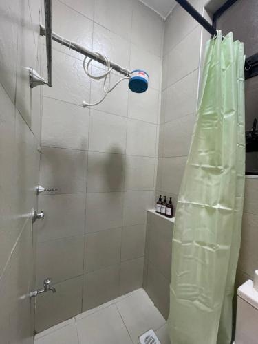 a shower with a glass door in a bathroom at Tulia, Anchor in Ruaka