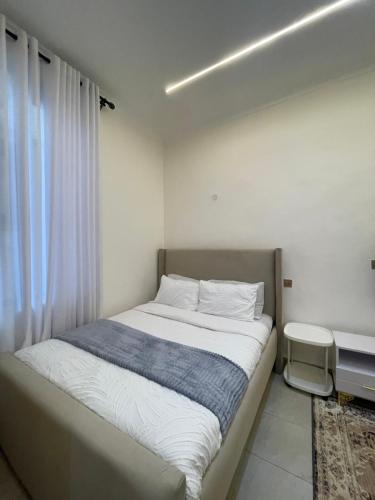 a bedroom with a large bed with a window at Tulia, Anchor in Ruaka