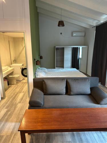 a living room with a couch and a bed at Bianco Boutique in Parga