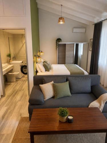a living room with a couch and a bed at Bianco Boutique in Parga