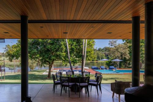 a patio with a table and chairs and a pool at Casa a jabuticabeira in Avaré