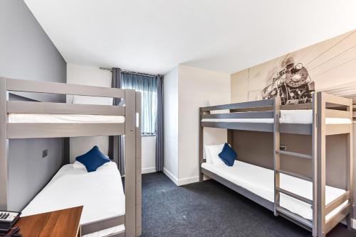 a bunk bed room with two bunk beds and a desk at Heeton Concept Hotel - City Centre Liverpool in Liverpool