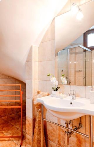 a bathroom with a sink and a mirror at Luxury Apartment with Pool in Pallini