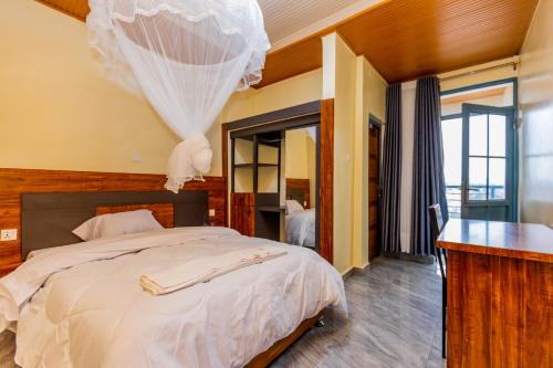 a bedroom with a bed with a net at Centre Missionnaire Lavigerie in Kigali