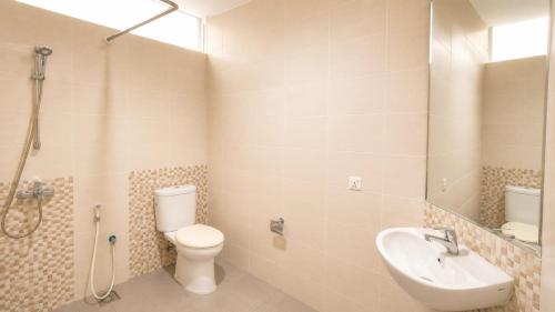 a bathroom with a toilet and a sink at SleepRest @ The Home Shoutlink in Nagoya