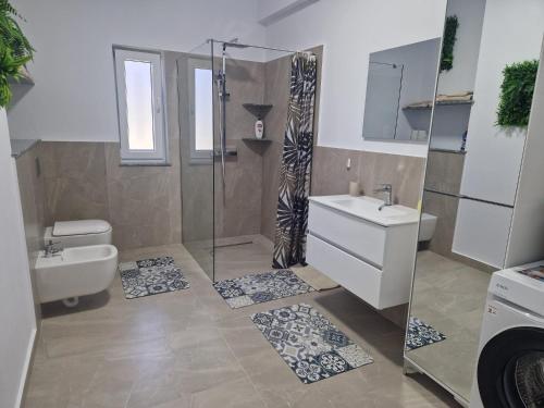 a bathroom with a shower and a sink and a toilet at Apartamente 2026 in Fălticeni