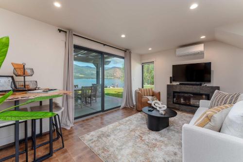 a living room with a couch and a tv and a fireplace at High-end Lakefront Condo B6 Wapato Point Chelan in Manson
