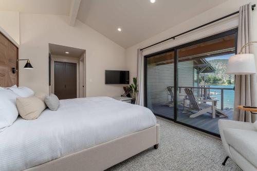a bedroom with a large bed and a balcony at High-end Lakefront Condo B6 Wapato Point Chelan in Manson