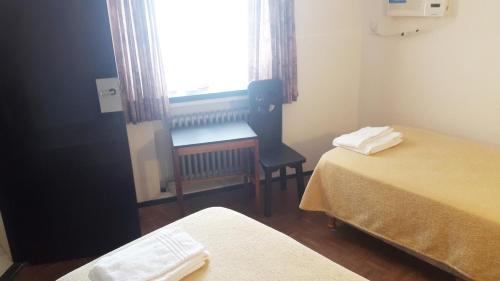 Ένα ή περισσότερα κρεβάτια σε δωμάτιο στο Hotel Regidor
