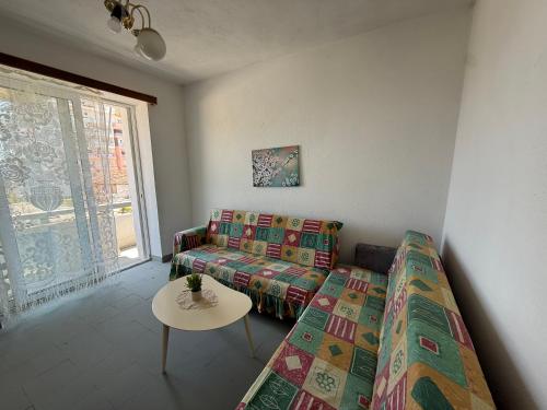 a living room with a couch and a table at Old Saranda Apartments in Sarandë
