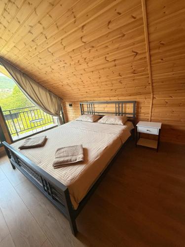 a large bed in a room with a wooden ceiling at NorWay1 in Ijevan