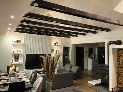 a living room with a couch and a table at Empyrean House in Dišnik