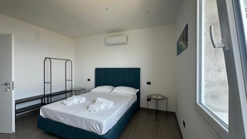 a bedroom with a bed with two towels on it at Torre Antica in Ioppolo