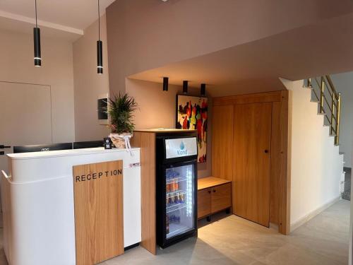 a kitchen with a refrigerator and a staircase at Kanaj Rooms and Apartments in Vlorë