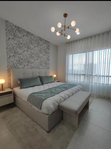 a large bedroom with a large bed and a chandelier at By Lumina Parvasa 1 in Ejido Parras