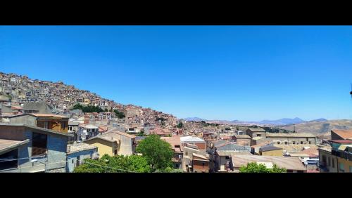 a view of a city with buildings on a hill at Camere DOMOVIEW- design con vista su Cammarata in San Giovanni Gemini