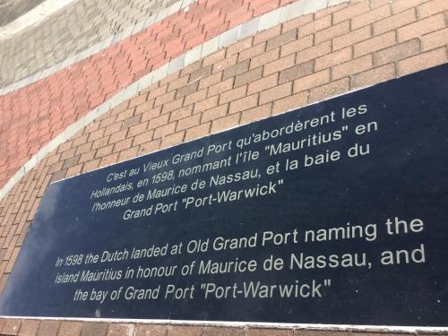 a sign on the side of a brick building at Orient Guesthouse Auberge in Mahébourg