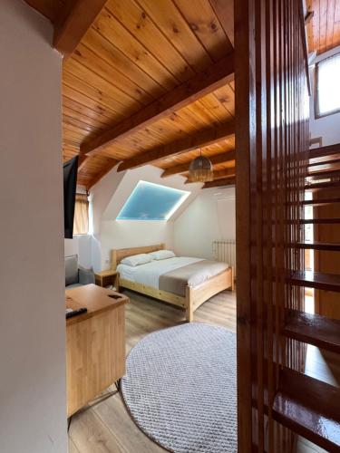 a bedroom with a bed and a desk in a room at Gegest Hotel in Theth