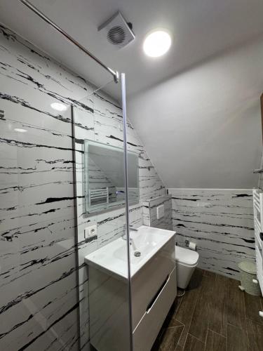 a bathroom with a sink and a toilet at Gegest Hotel in Theth