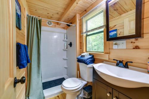 a bathroom with a sink and a toilet at Catskills Tiny Home Cabin: Surrounded by Nature! in Franklin