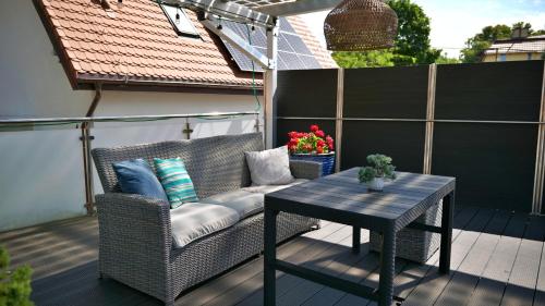 a wicker chair and a table on a patio at Nadmorska Miła in Gdańsk