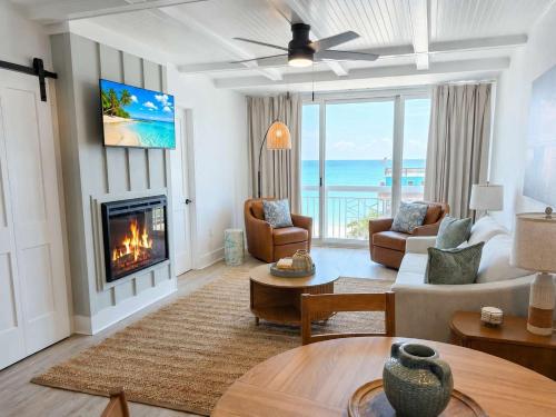 a living room with a fireplace and a view of the ocean at Lavish Coastal Oceanfront Suite Yachtsman 401 in Myrtle Beach