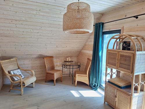 a room with chairs and a table and a window at Mazurska Widokówka in Węgorzewo
