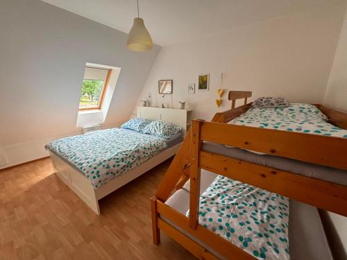 a bedroom with two bunk beds and a window at Apartmán Deštná čp.1 in Deštné v Orlických horách