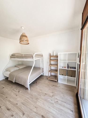 a bedroom with a bunk bed and a wooden floor at La maison IDEL in Yvonand