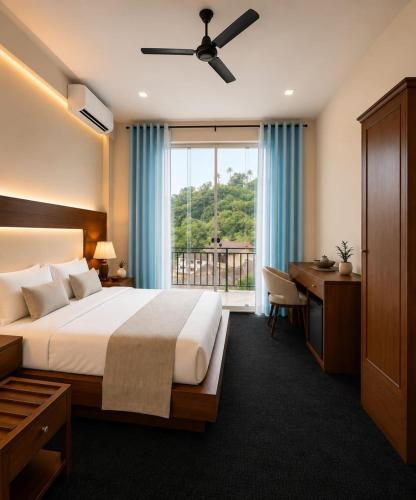 a bedroom with a bed and a desk and a window at Hotel Velmont Kandy in Kandy