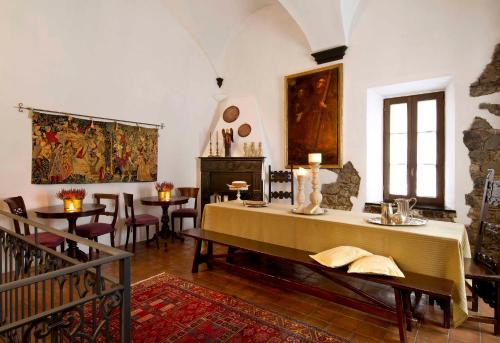 a room with a table and chairs and a painting at Abbadia San Giorgio in Moneglia