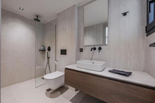 a bathroom with a sink and a toilet and a shower at Nysa Luxury villas 3-4-5-6 in Heraklion