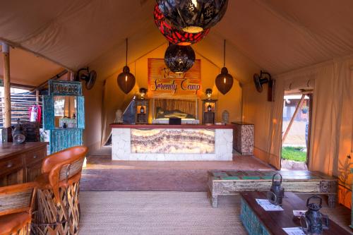 a living room with a fireplace in a tent at Serenity Authentic Glamping Tulum in Xpu Ha