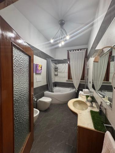 a bathroom with a sink and a toilet and a tub at Sister House in Cerignola