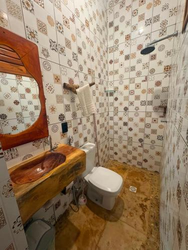 a bathroom with a toilet and a sink in it at Point lanabarra in Amontada