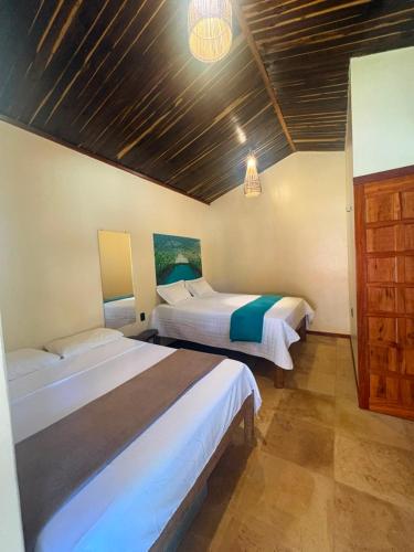 a bedroom with two beds in a room at Point lanabarra in Amontada