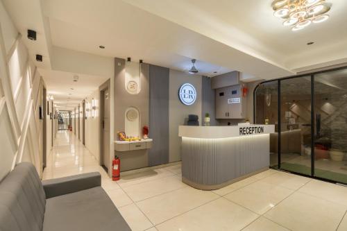 a lobby of a hospital with a reception counter at Hotel Lavish Regency in Ahmedabad