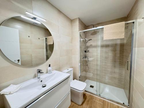 a bathroom with a toilet and a sink and a shower at Residencial Junceda in Viveiro