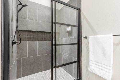 a shower with a glass door in a bathroom at Timber and Trail in Kimberling City