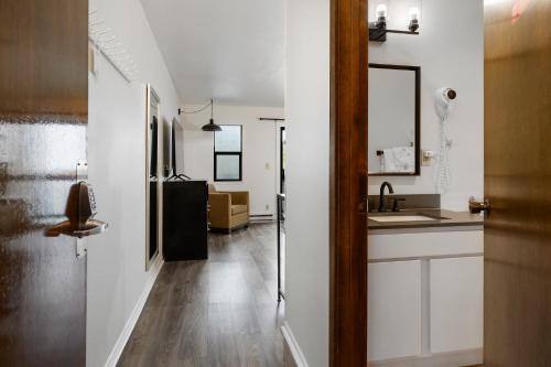 a hallway with a sink and a kitchen with white walls at Anchor Lodge in Fort Bragg