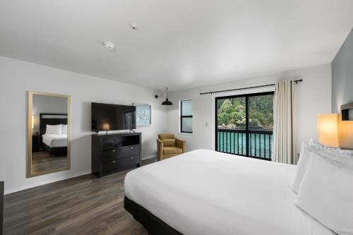 a hotel room with a bed and a window at Anchor Lodge in Fort Bragg