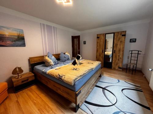 a bedroom with a bed with a cat sitting on it at Idylle Ostsee in Buggenhagen
