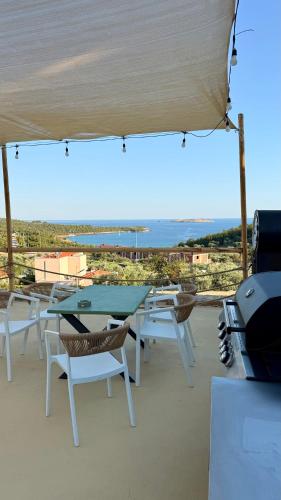 a table and chairs with a view of the ocean at Olea Village in Potos