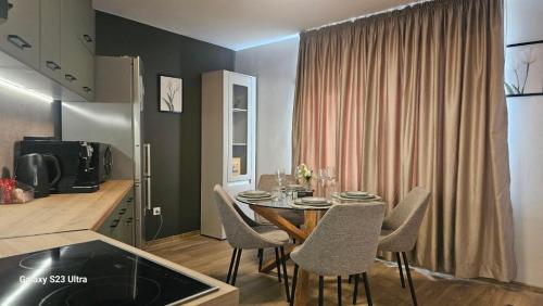 a kitchen and dining room with a table and chairs at Casmere Suite in Pomorie