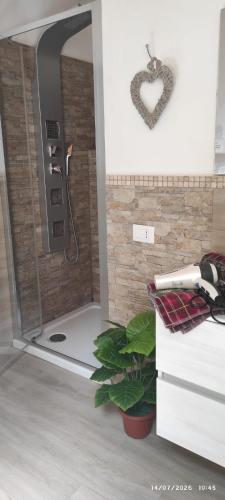 a bathroom with a shower with a heart on the wall at HOME DOLCE LUNA in Castelvetrano Selinunte