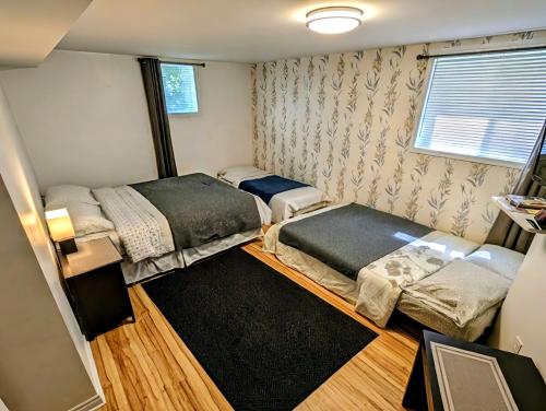 a small room with two beds and a window at Cedar Drive Inn in Crysler