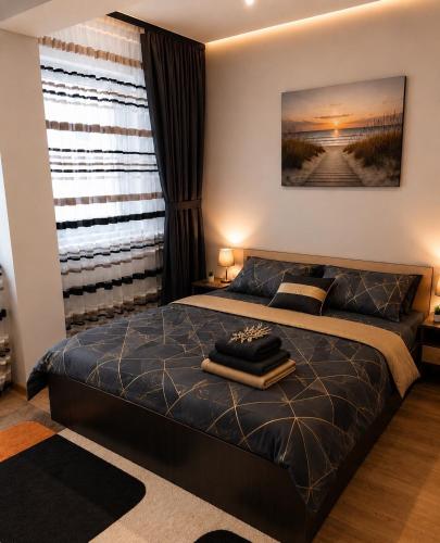 a bedroom with a bed and a large window at Yoa Apartaments in Floreşti