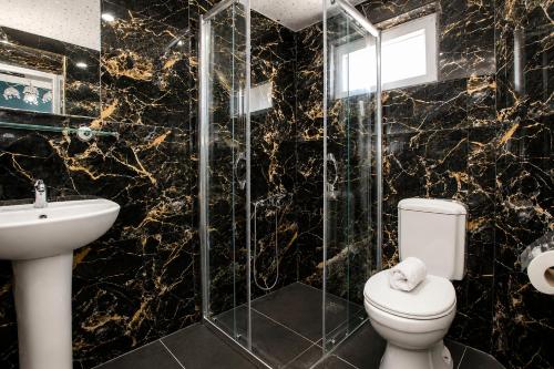 a bathroom with a toilet and a sink and a shower at Dublin Hotel in Alanya