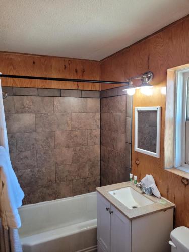 a bathroom with a sink and a bath tub at Sterling Gardens in Las Vegas
