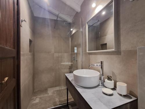 a bathroom with a sink and a shower at Nykteri Heritage House Olympus & Sea View in Palaios Panteleimonas